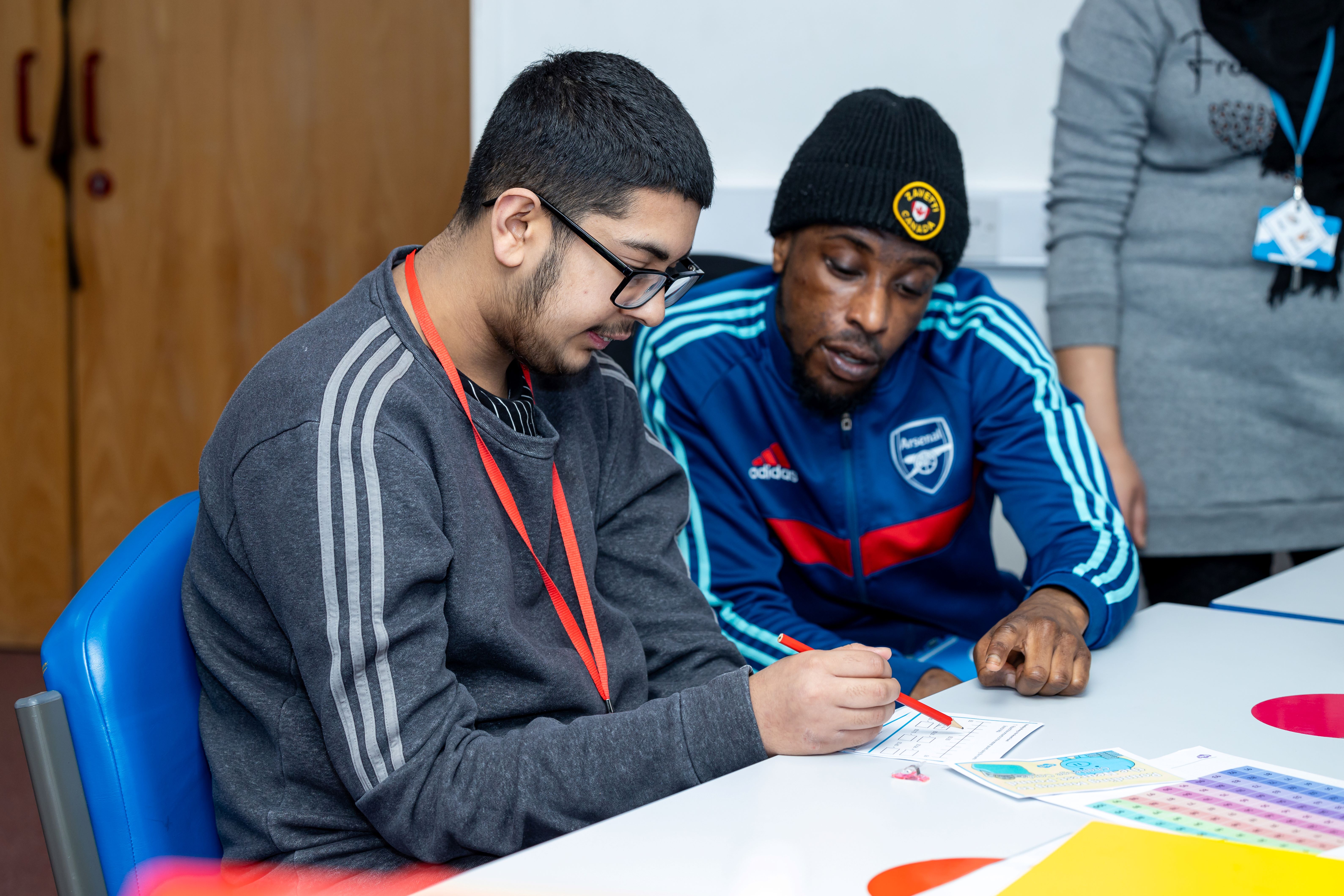 Staff member supports student in a classroom