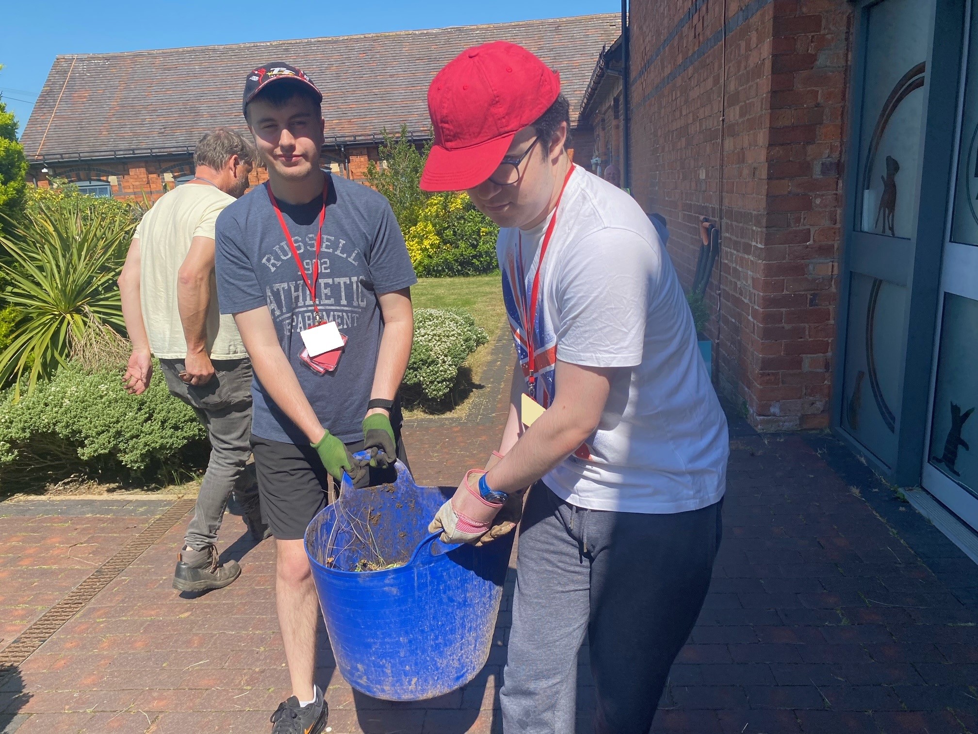 PFL red students carrying a bucket 