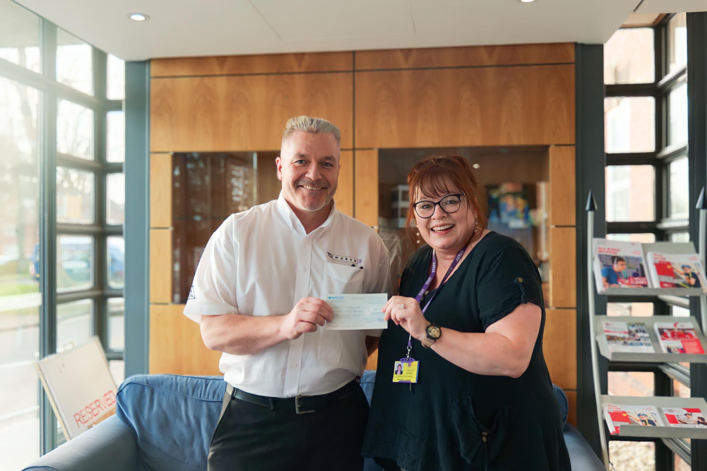 Bev and Barry holding the cheque