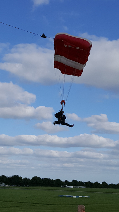 A Skydiver about to land from their jump