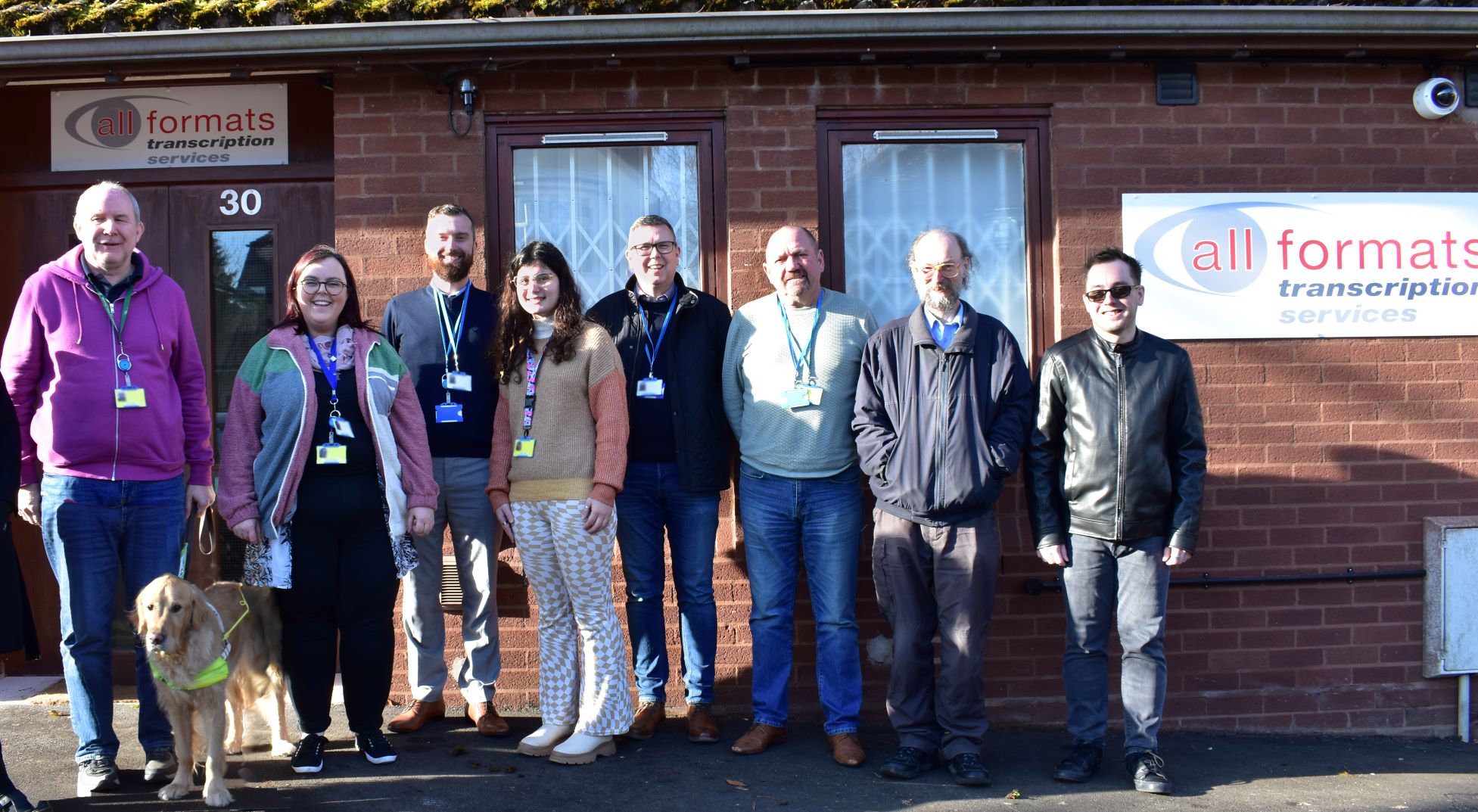 AllFormats staff standing in front of their new building