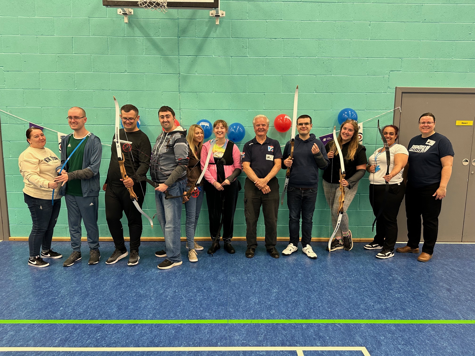 Group photo of QAC students and GB archery staff 