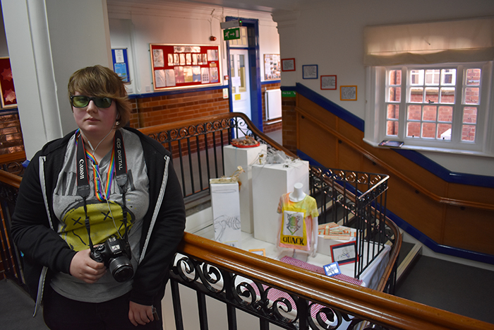 QAC Student Beth poses in front of her exhibition