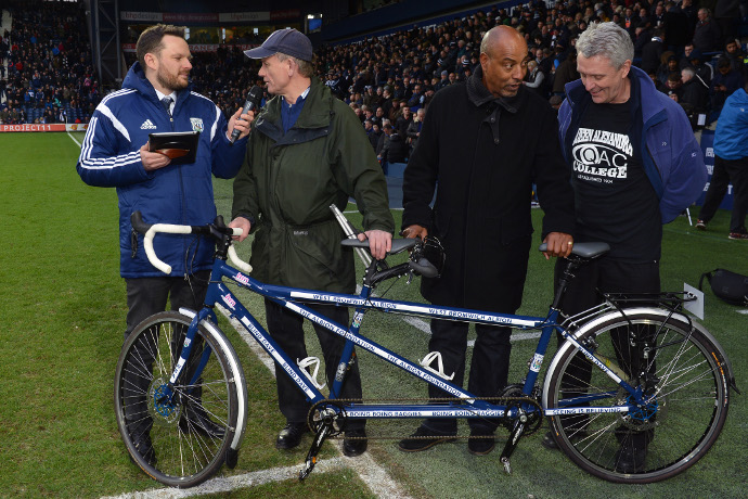 Blind Dave being interviewed pitch side behind his Tandem Bike