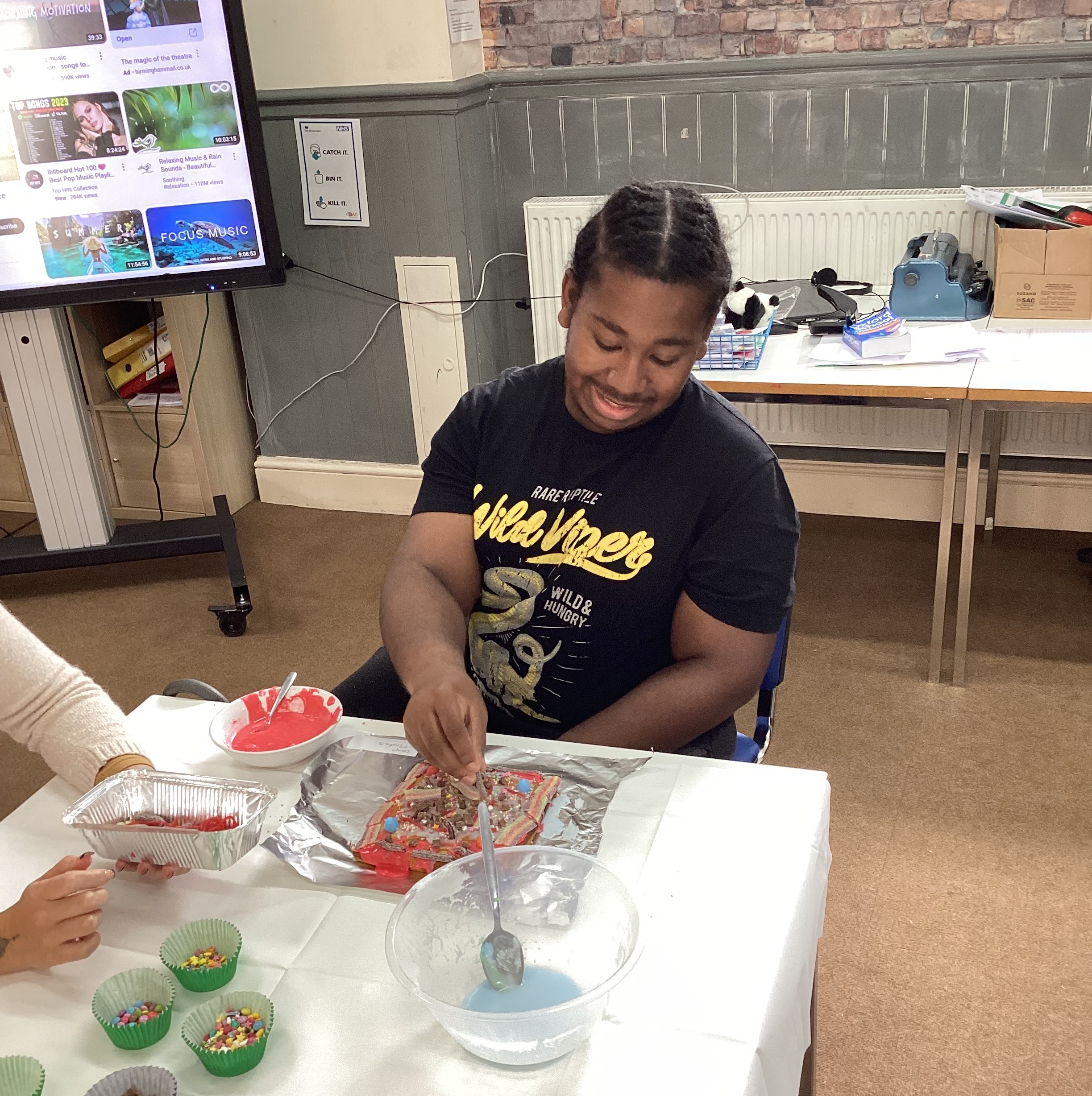 Student decorating a cake