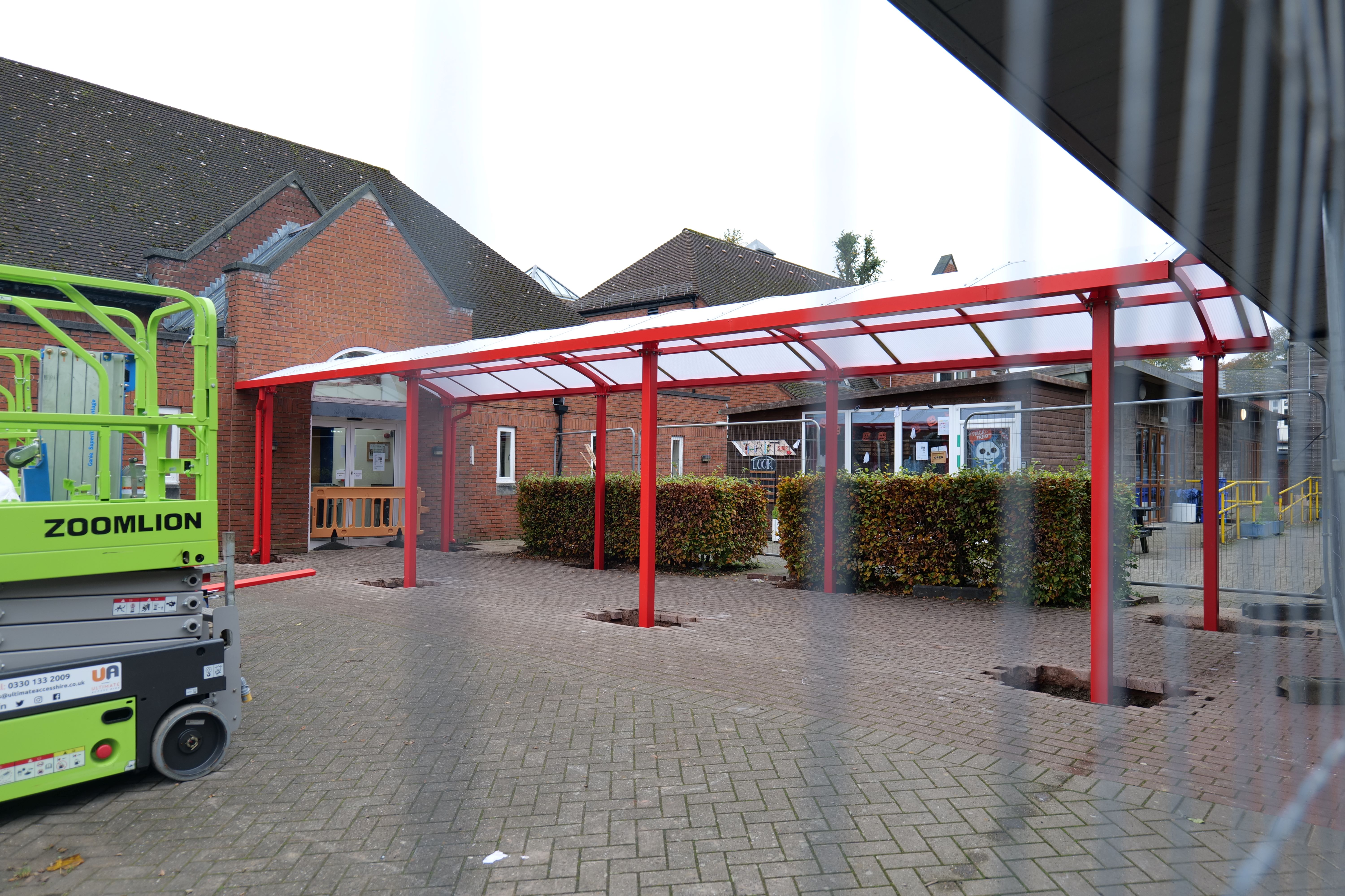 Image of the new canopy on the campus with red stands