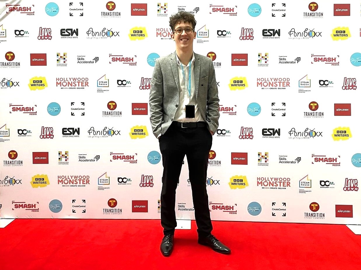 Charlie smiling on the red carpet