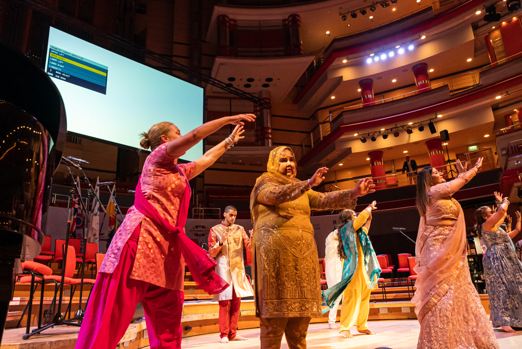 Maryam and other dancers performing on a stage in the Opening Ceremony