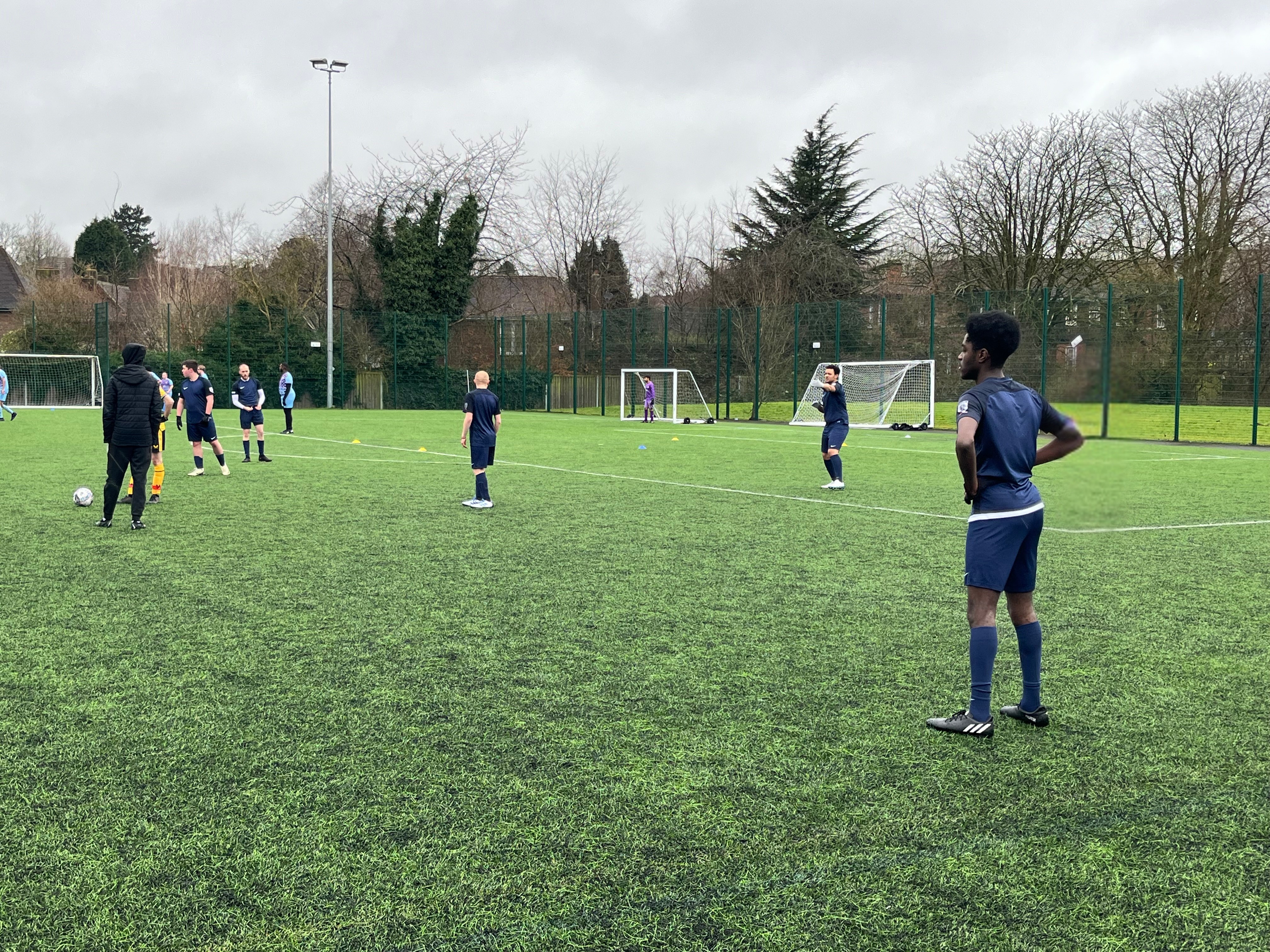 QAC Football team standing on a pitch 