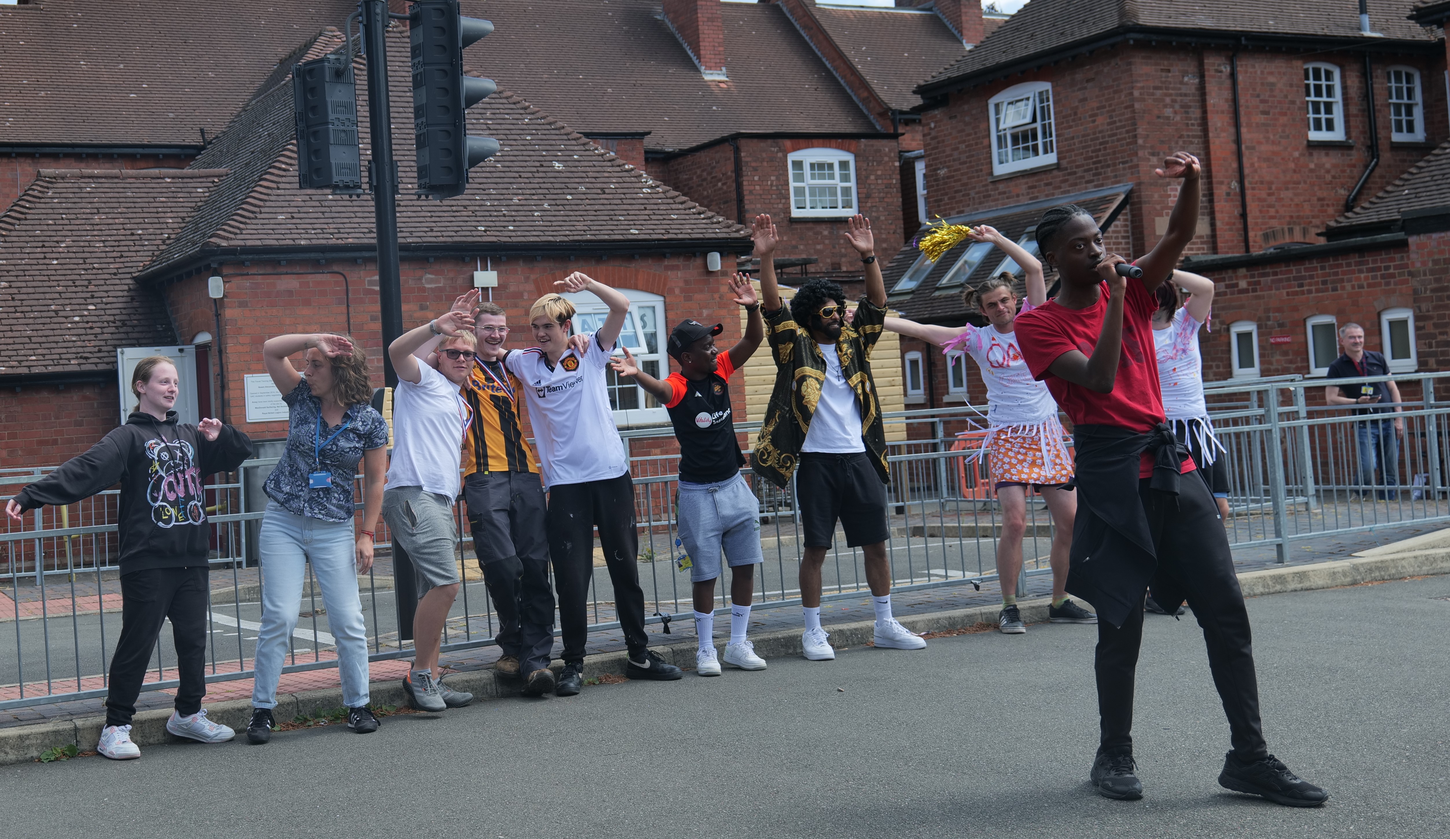 QAFactor winner performing and students dancing 