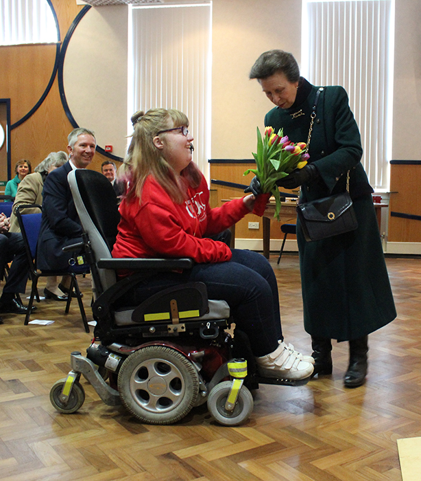 QAC Student Ambassador Hannah presenting HRH The Princess Royal with a bouquet of flowers