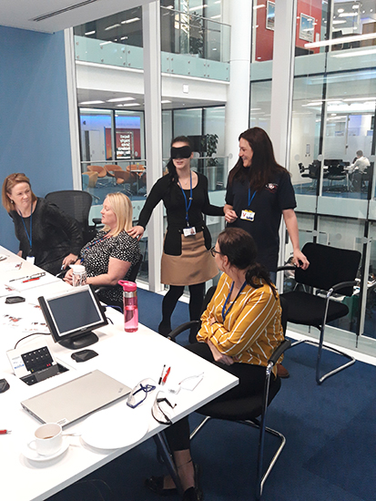 Rehab and Travel Training officer Emma teaching Barclays staff some Sighted Guide techniques