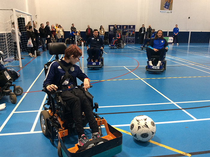 Powerchair Football student Amy in a game against West Bromwich Albion footballers