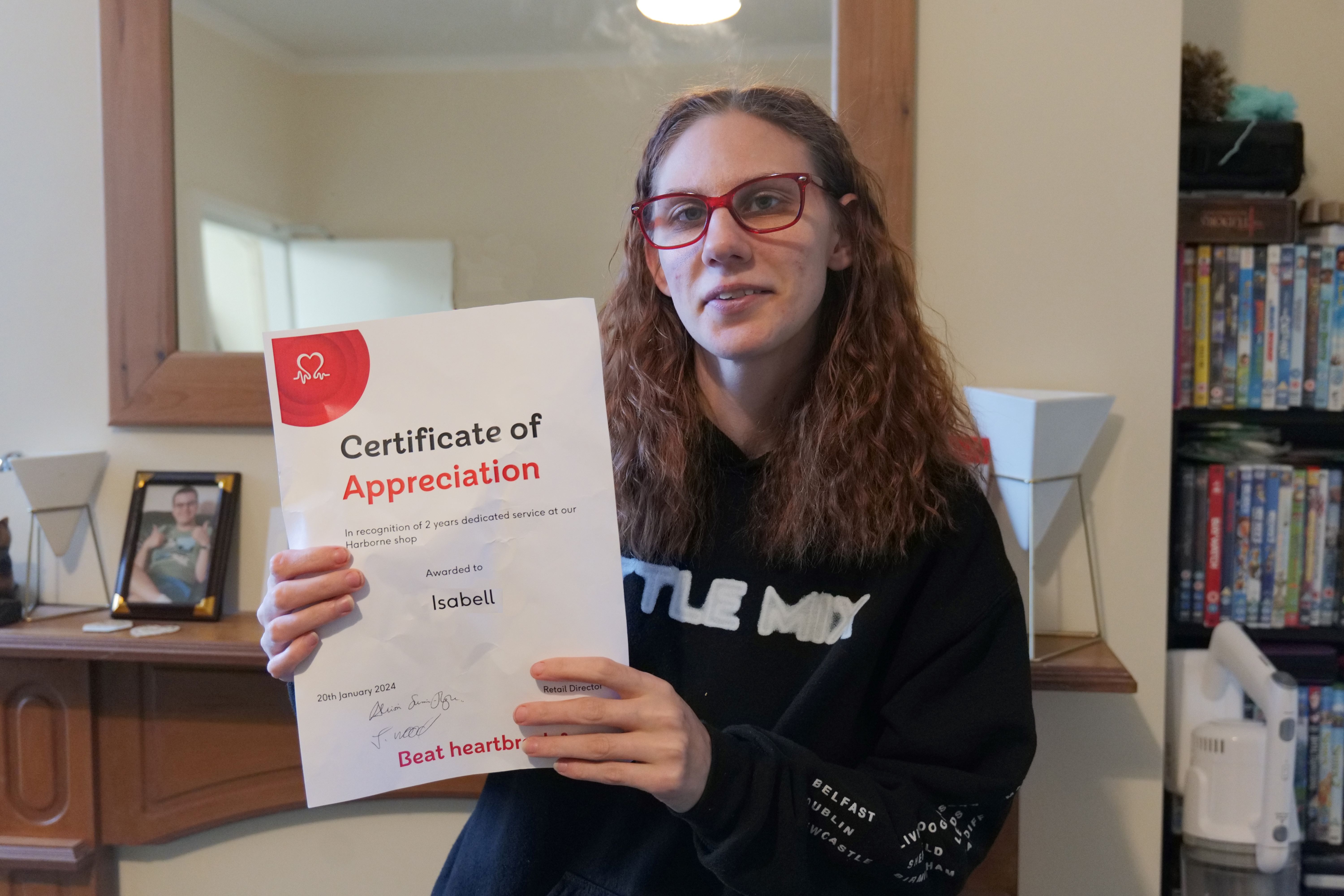 Izzy holding her certificate