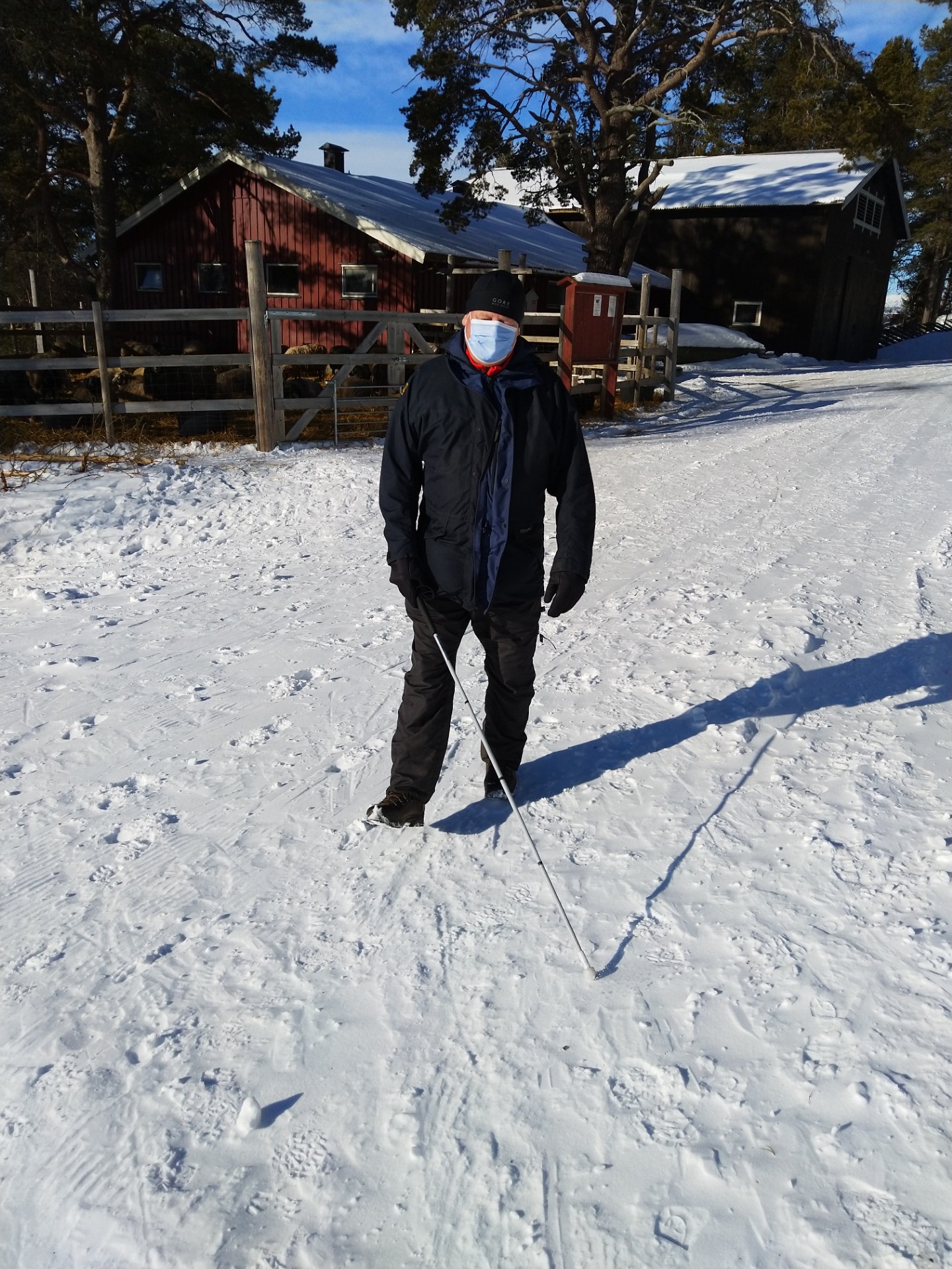 Image of Jimmy facing the camera holding his cane