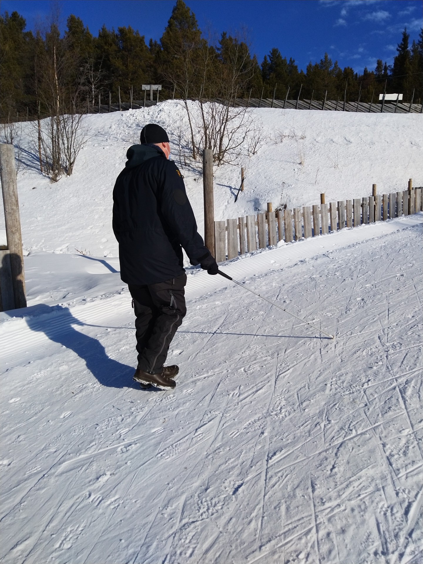 Image of Jimmy walking in the snow using his cane