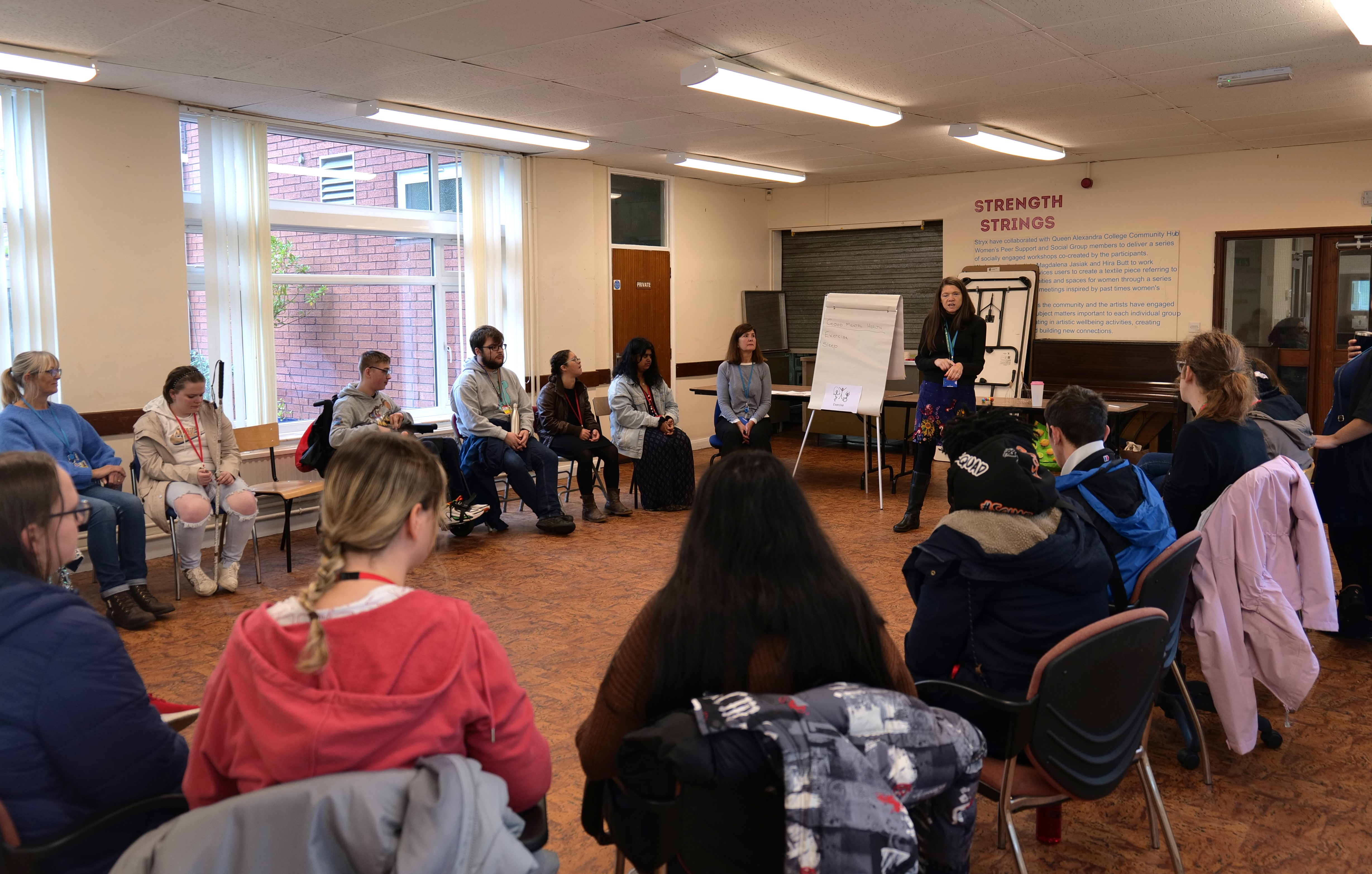 QAC students talking in a group session with Sarah 