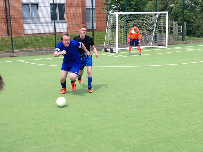 2 football players going head to head for the ball during the Natspec games