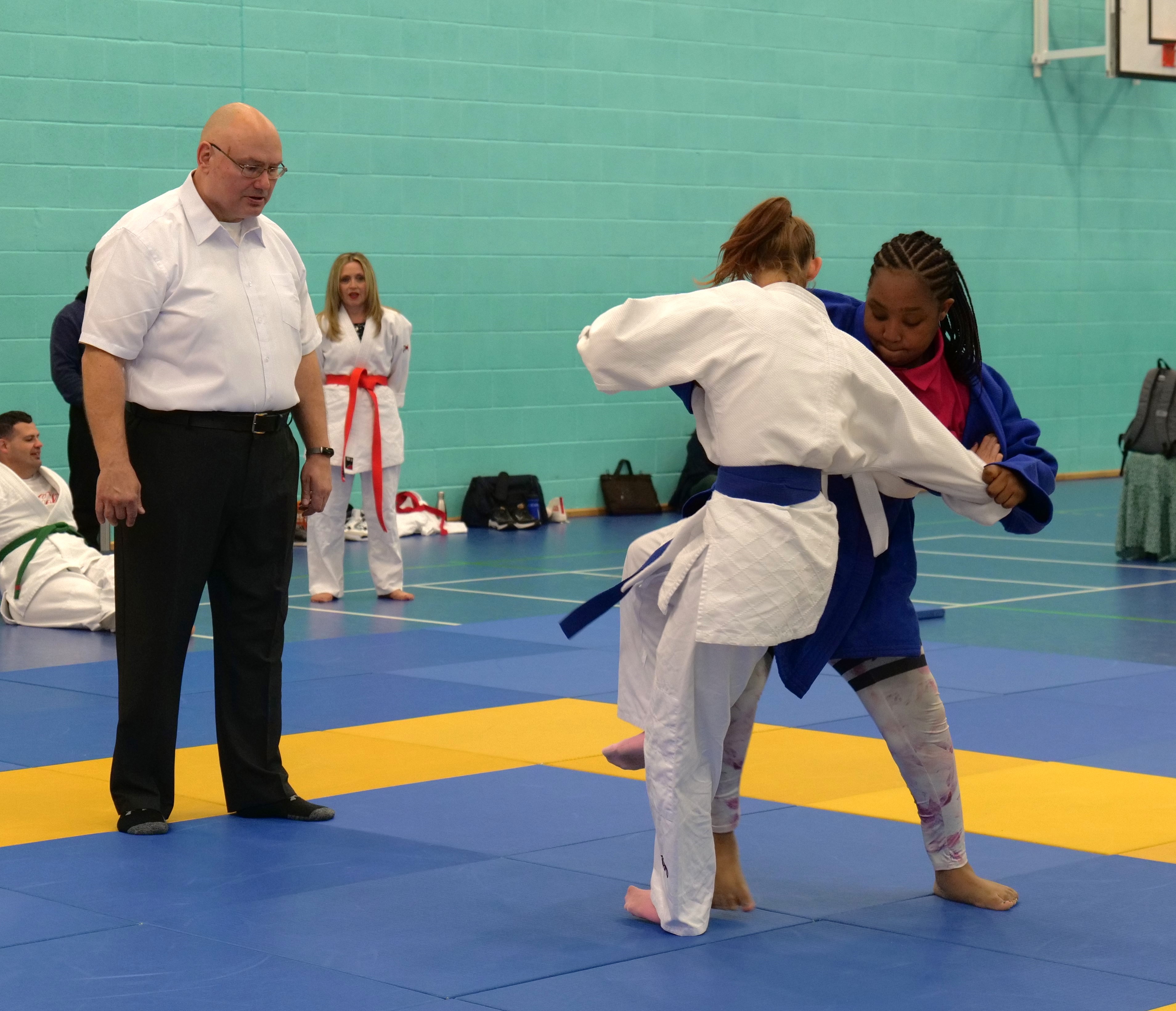 Two students competing in a judo competition