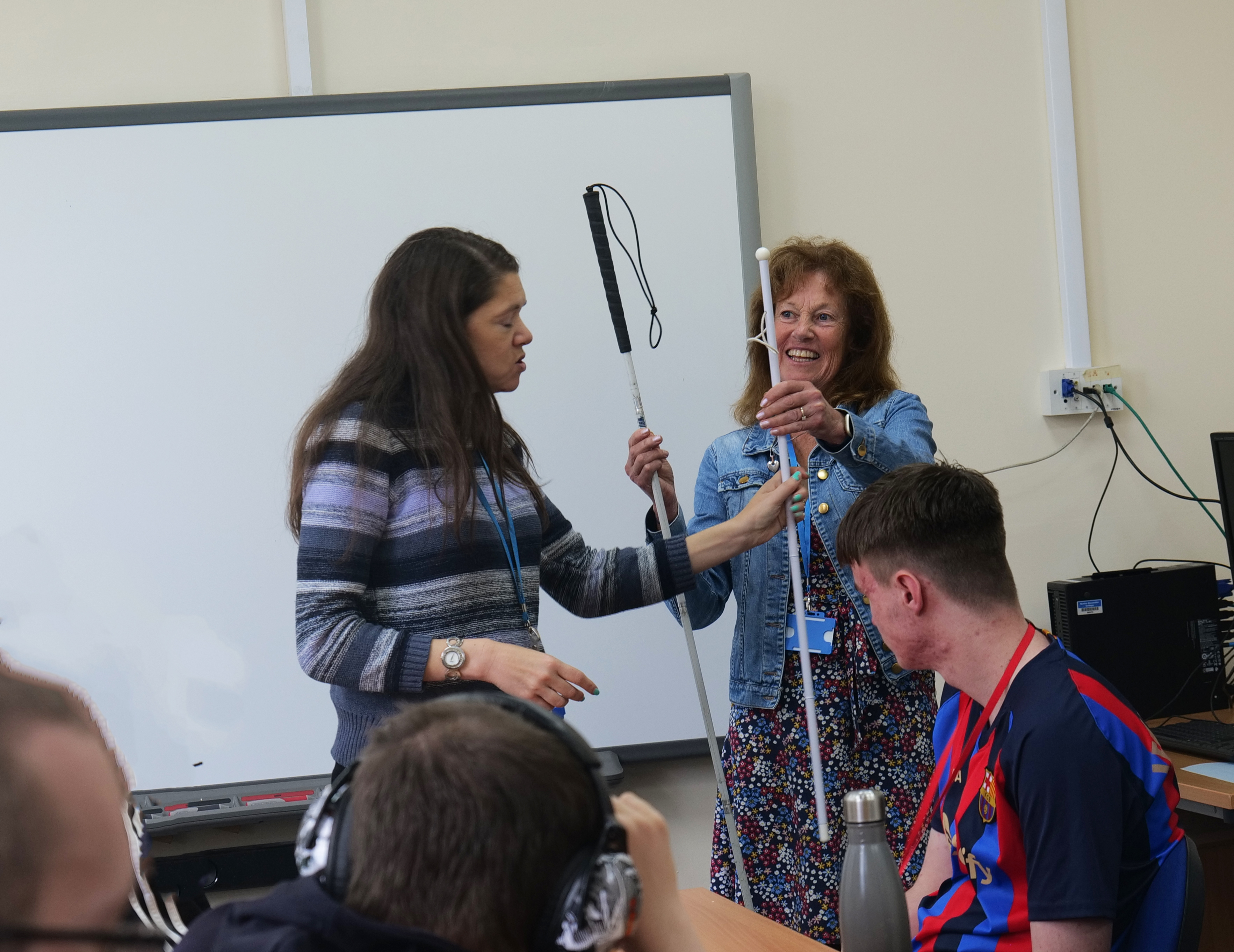 Sarah and showing a long cane and a symbol cane