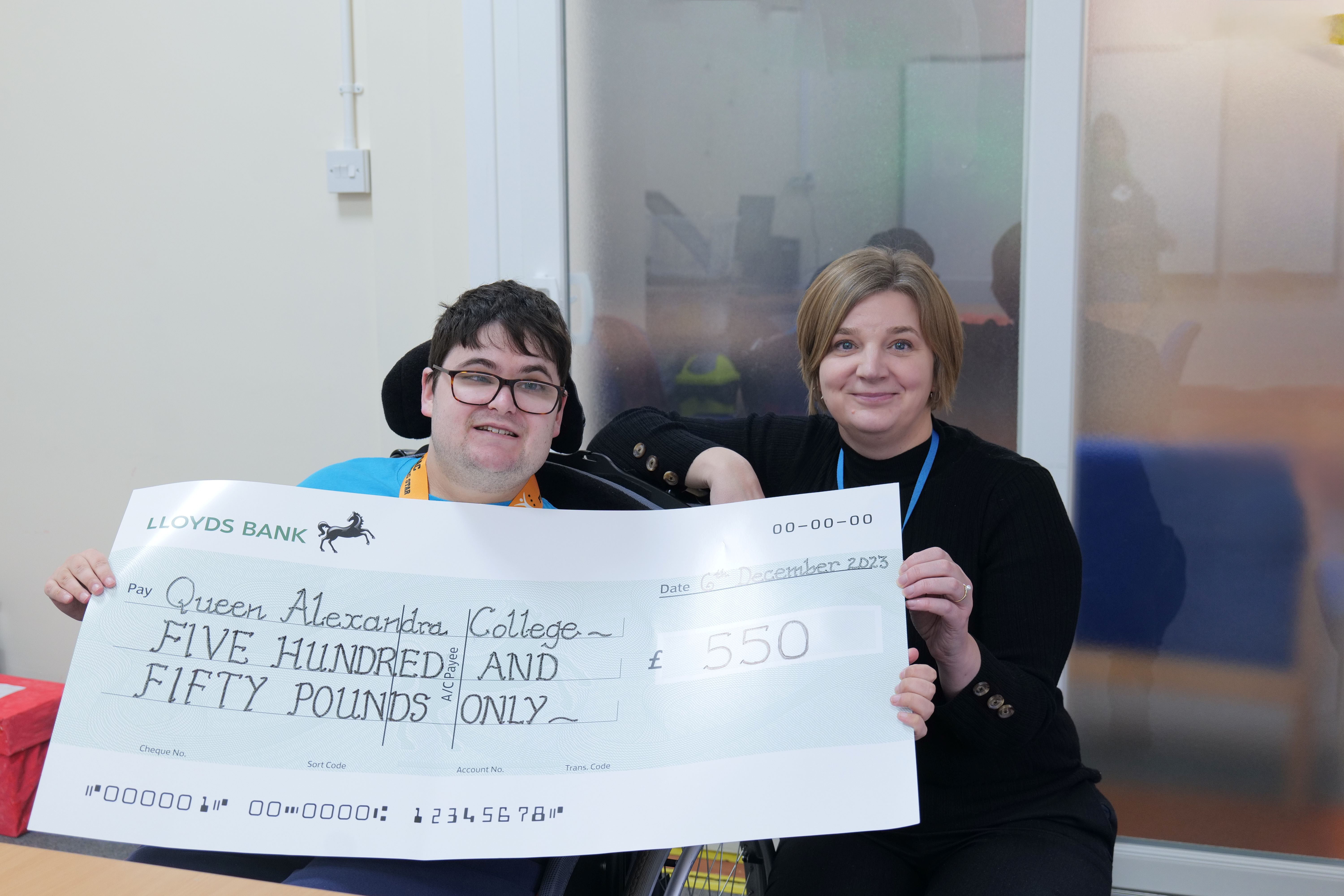 Conor and Cathryn holding a cheque