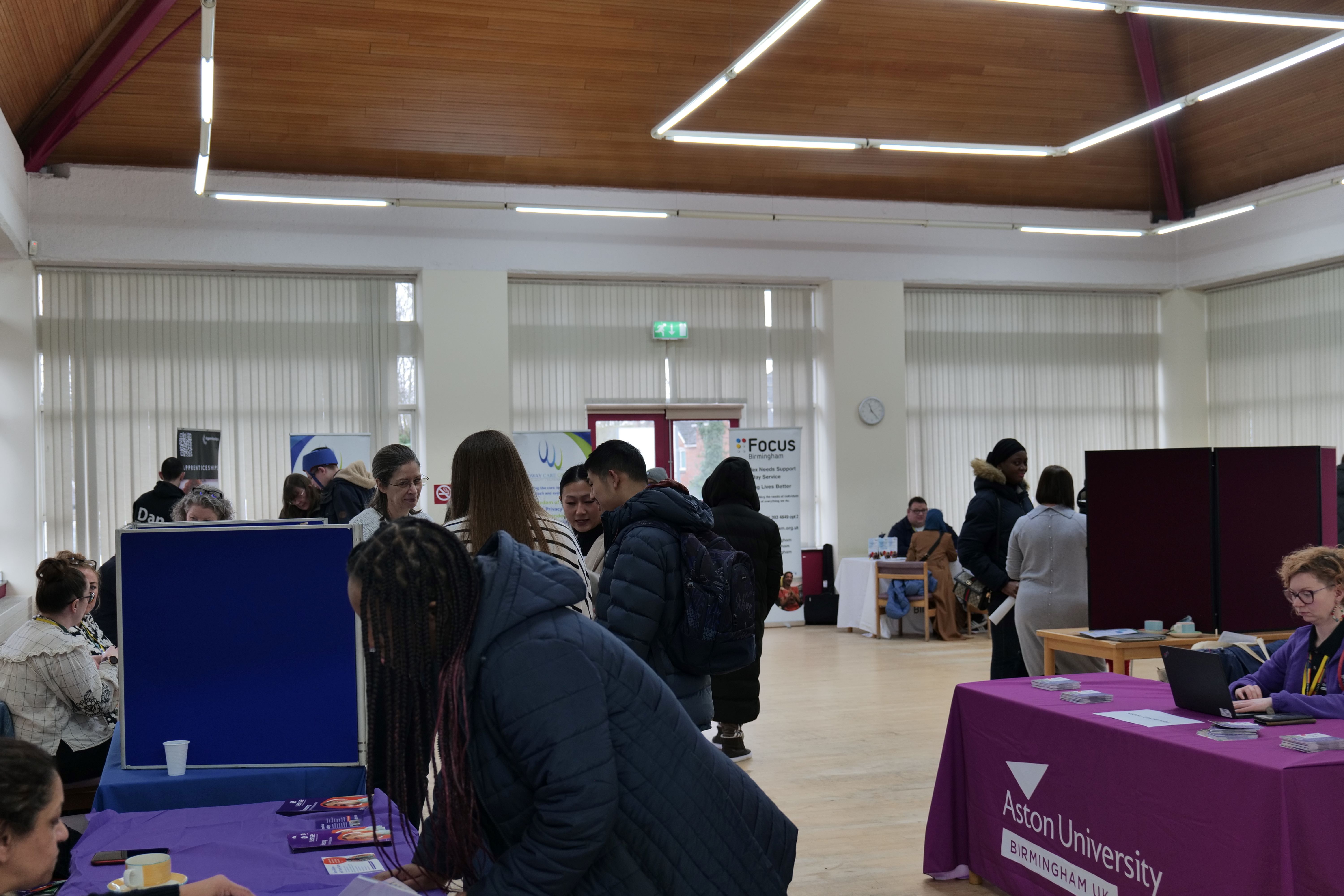 QAC students and families talking to exhibitors