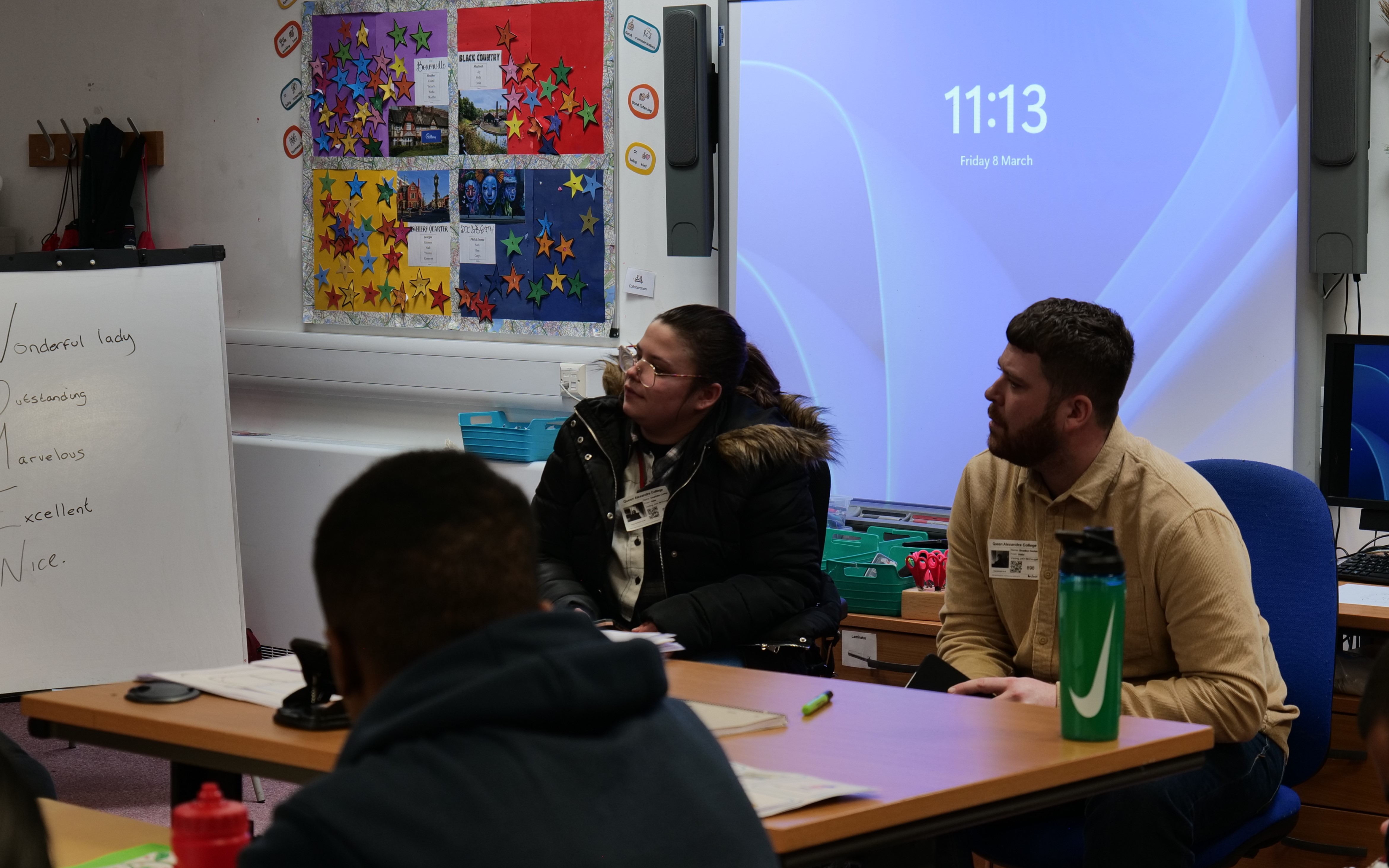 Charlotte and her boss talking to QAC students