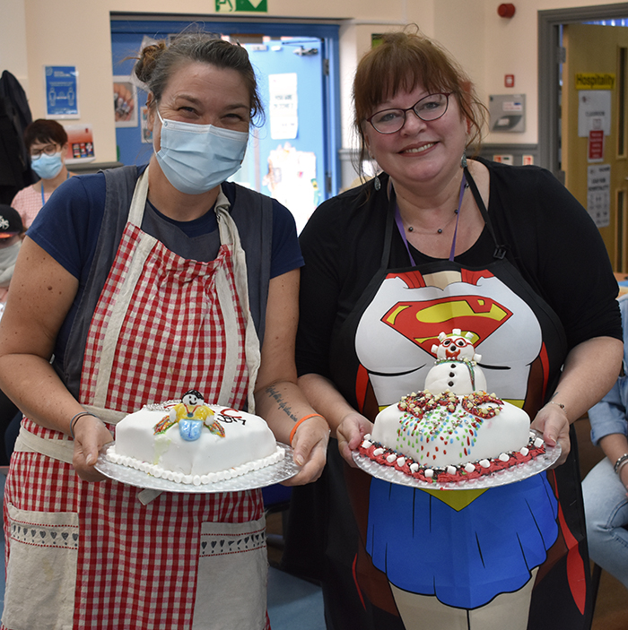 Jan and Bev holding their cake decorating creations