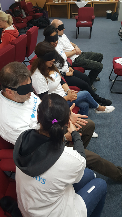 Barclays staff take part in a blindfolded activity with the mobility team