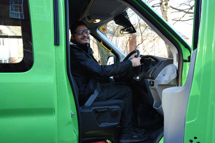 QAC student Pritesh in the drivers seat of the minibus