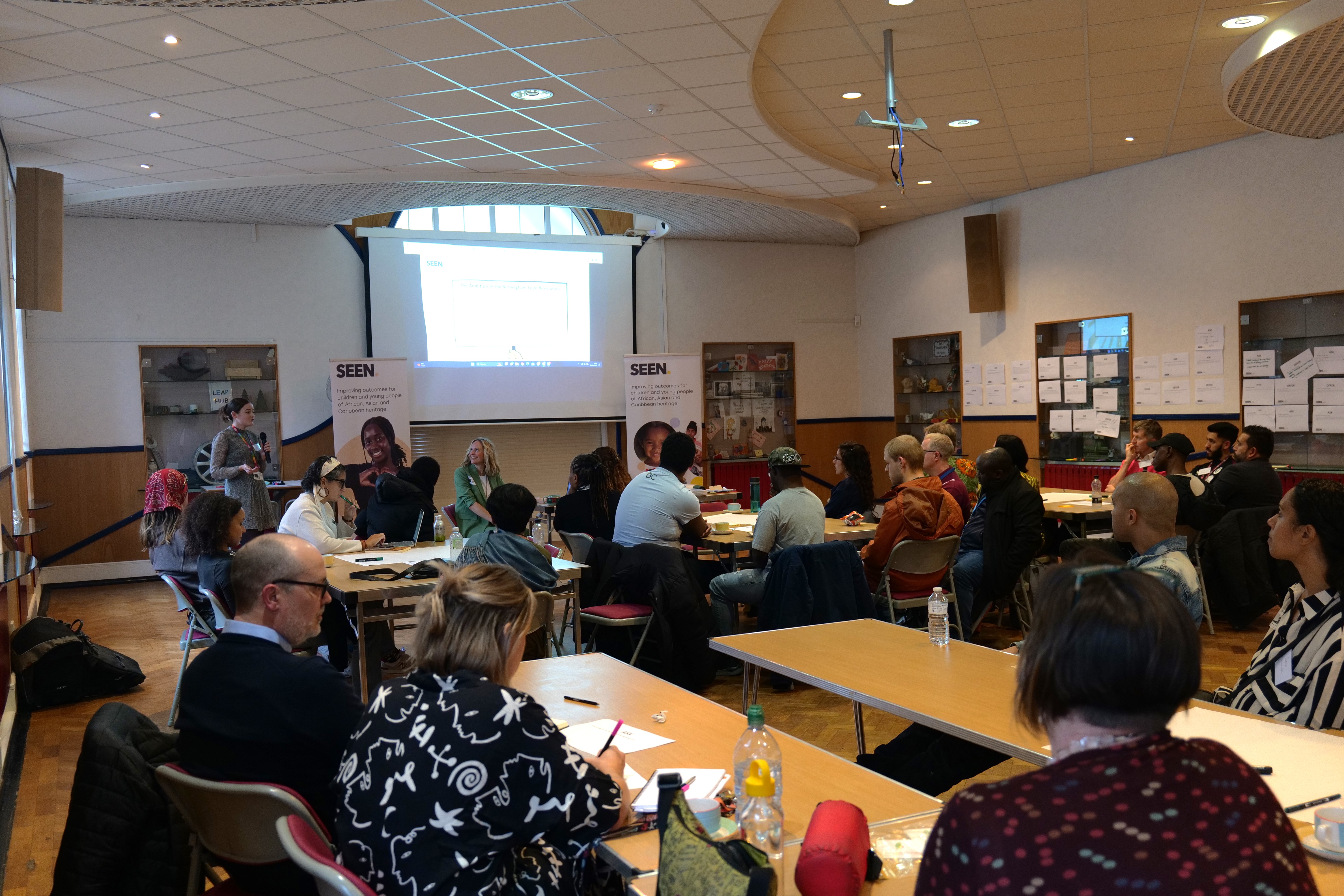 Delegates presenting to visits in the hall