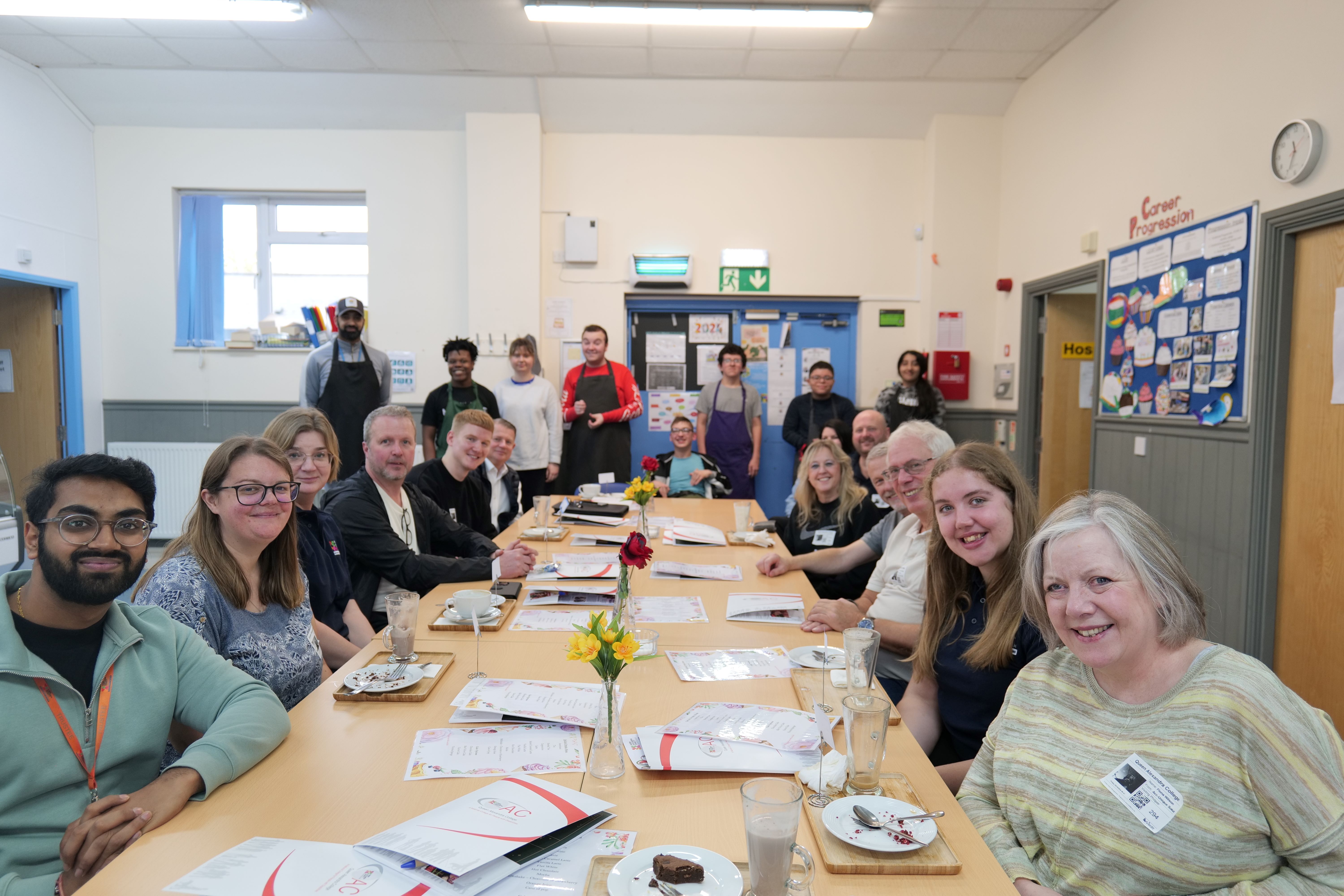 Image of the SporTea representatives and QAC student sat at the table