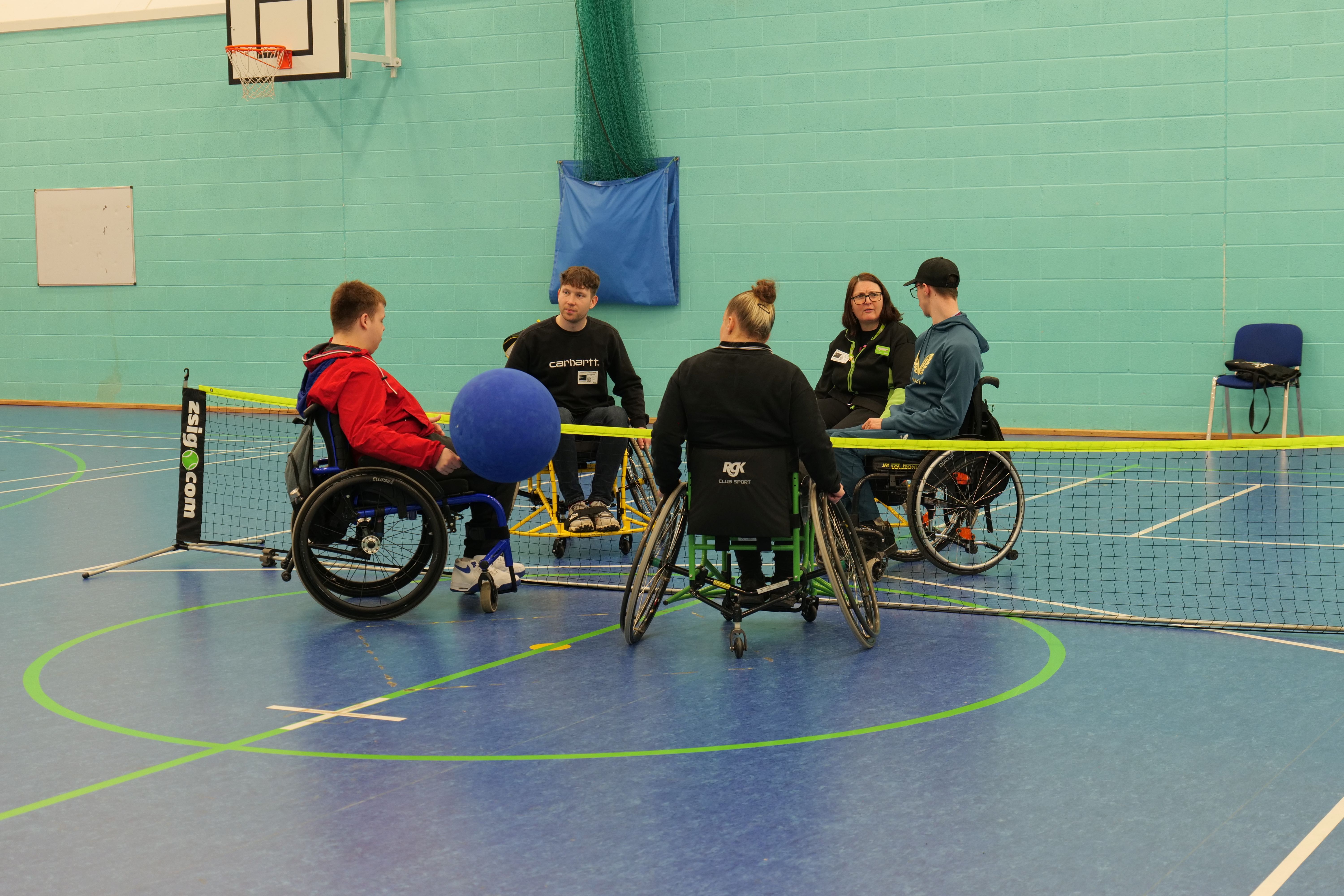 Sport students talking to visitors whilst playing accessible sports