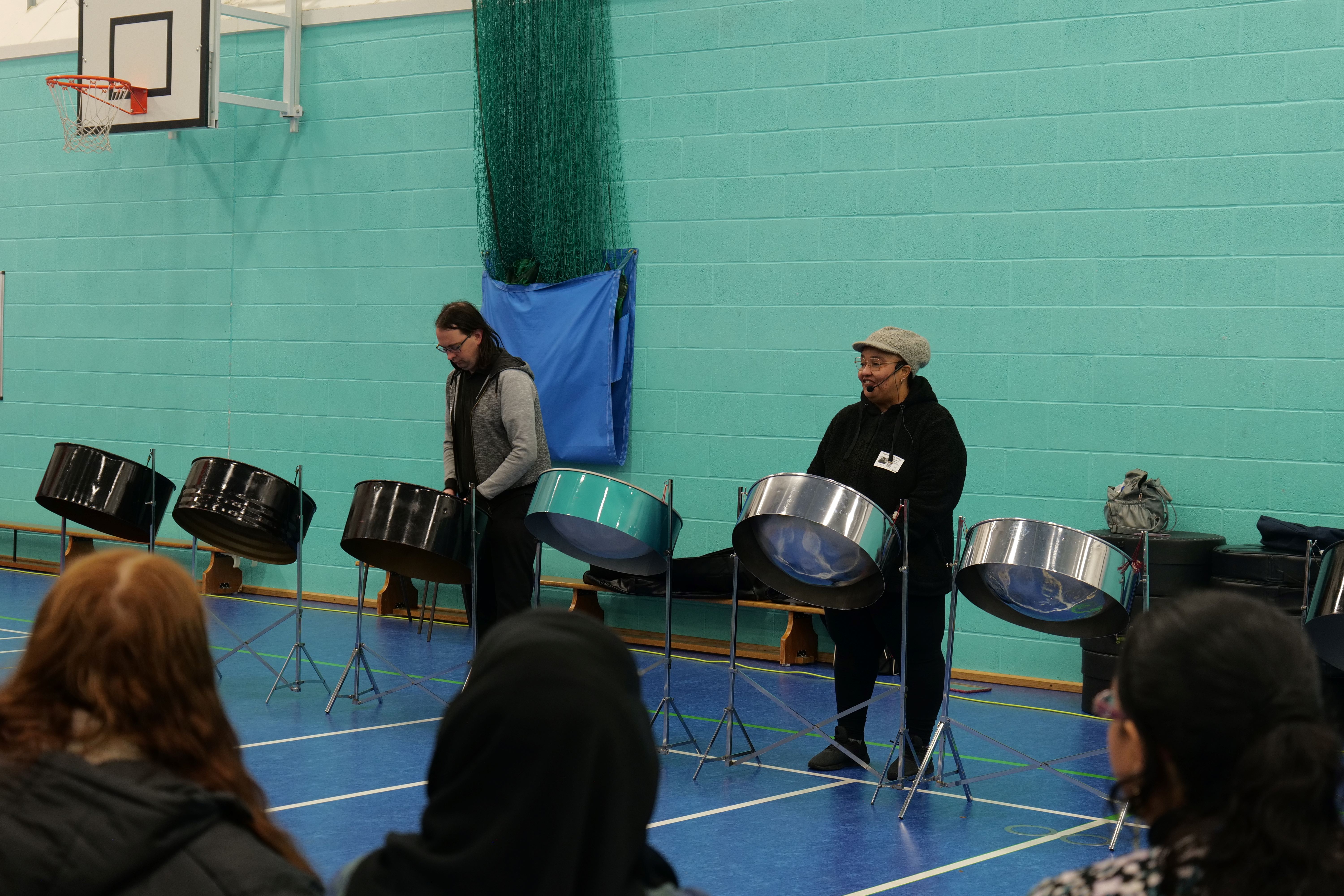 Visitors playing on steel drums