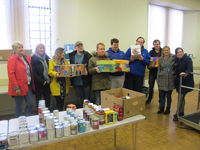 Students and staff posing for photo with their food parcels