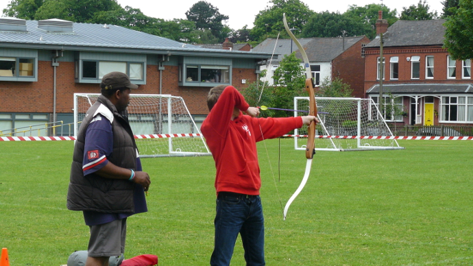 A person trying Archery during the Summer Fete