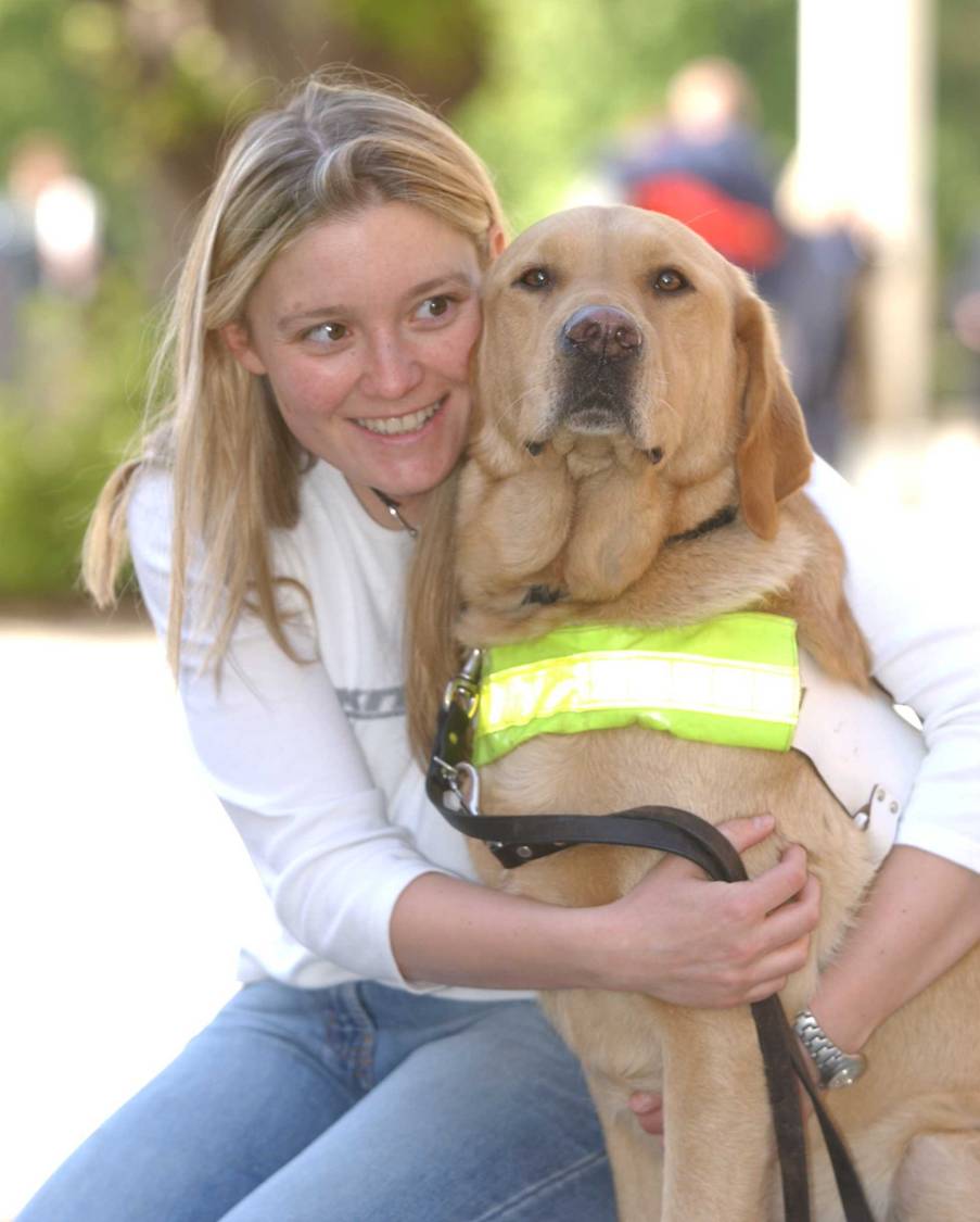 Girl sitting with Guide Dog